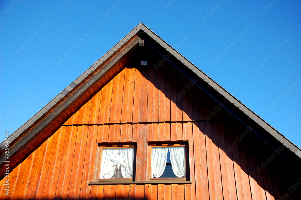 Holzhaus Giebel Fenster mit Vorhängen