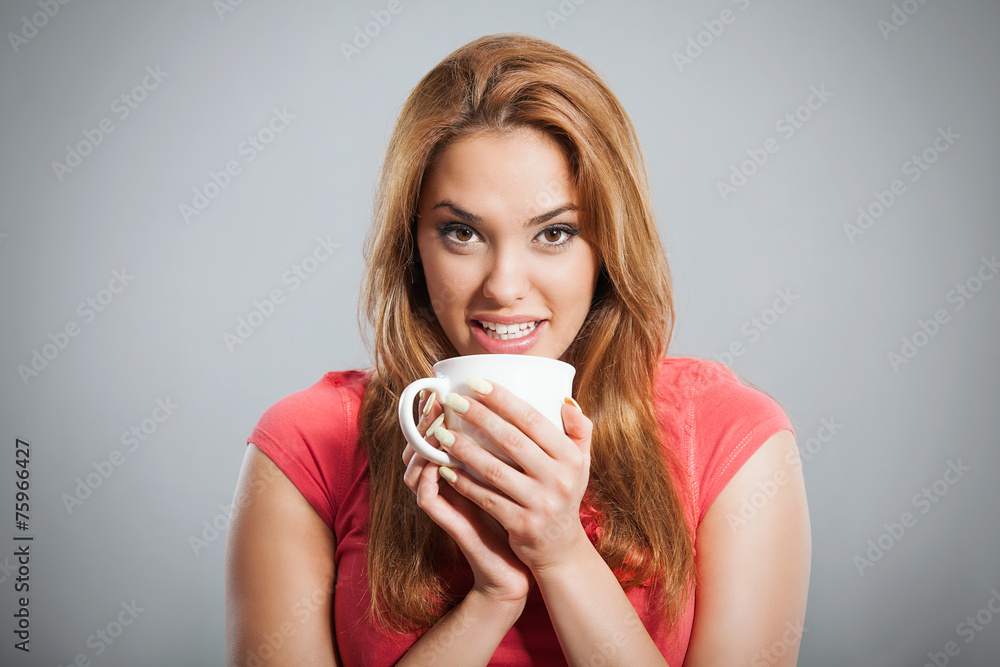 Portrait of a young woman having a cup of hot drink. Portrait of a young woman having a cup of hot drink.