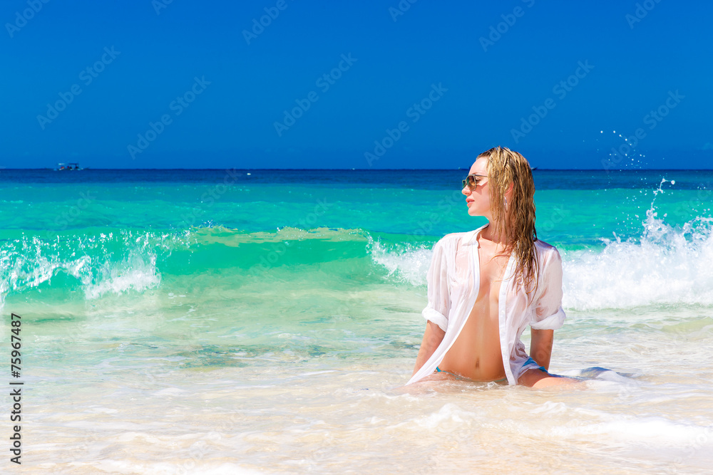 liberal Outward fry Young beautiful girl in wet white shirt on the beach. Blue trop Stock Photo  | Adobe Stock