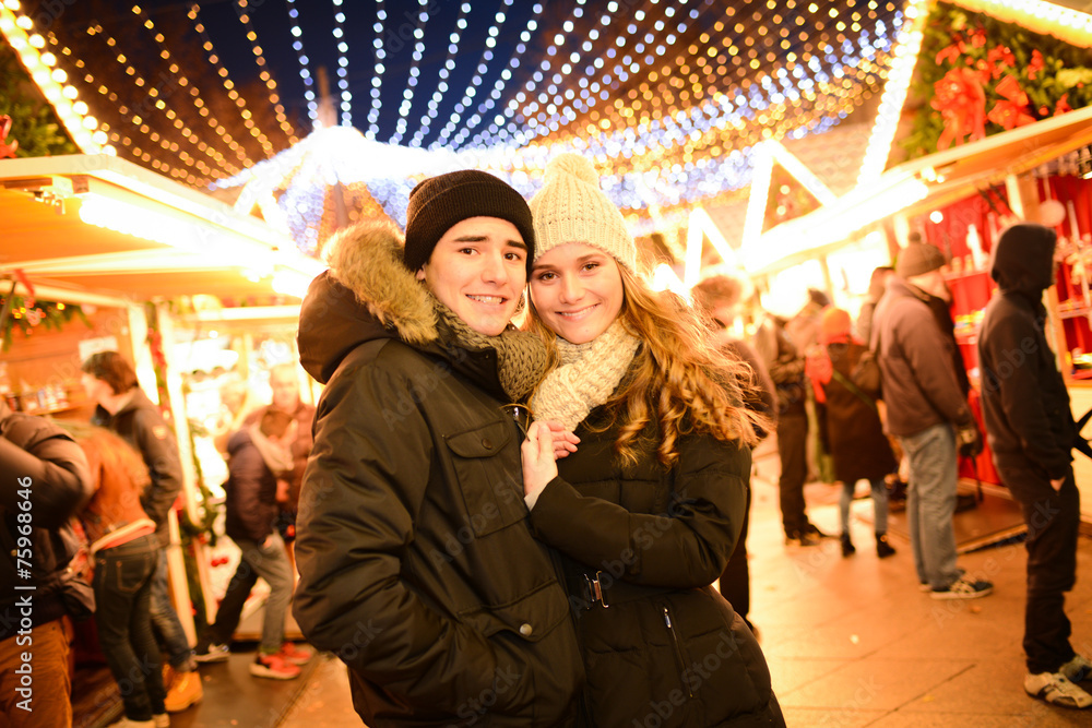 happy young couple having fun in town at night during winter