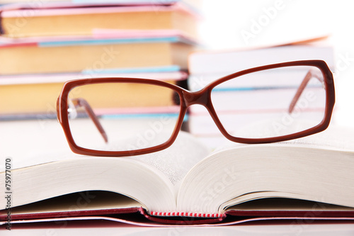 Composition with glasses and books, isolated on white