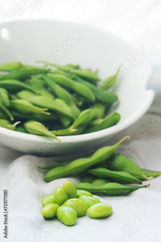 boiled green soybeans on fabric background