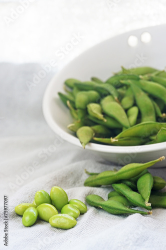 boiled green soybeans on fabric background