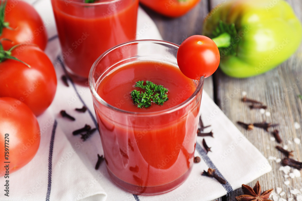 Tomato juice in glasses and fresh vegetables Tomato juice in glasses and fresh vegetables