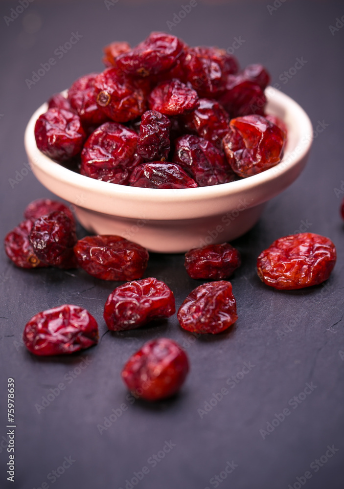 dried cranberries in a wooden spoon.fruit full of vitamin c. dried cranberries in a wooden spoon.fruit full of vitamin c.