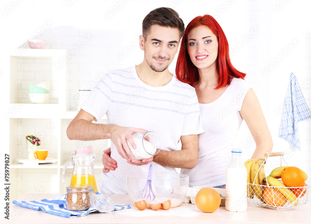 Happy couple preparing dough baking in kitchen