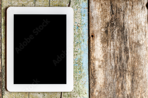 Digital tablet PC on wooden background