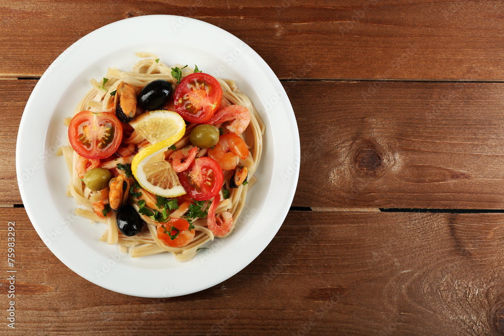 Tasty pasta with shrimps, mussels, black olives and tomato Tasty pasta with shrimps, mussels, black olives and tomato