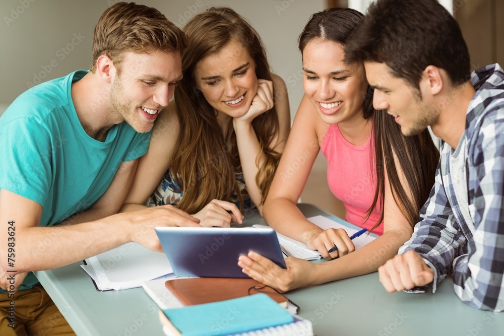 Smiling friends sitting using tablet pc Smiling friends sitting using tablet pc