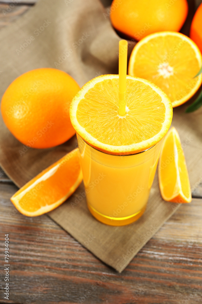 Glass of orange juice with straw and slices Glass of orange juice with straw and slices