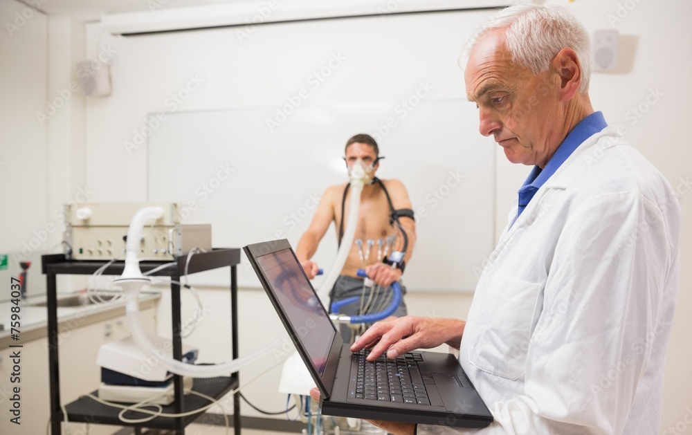 Man doing fitness test on exercise bike Man doing fitness test on exercise bike