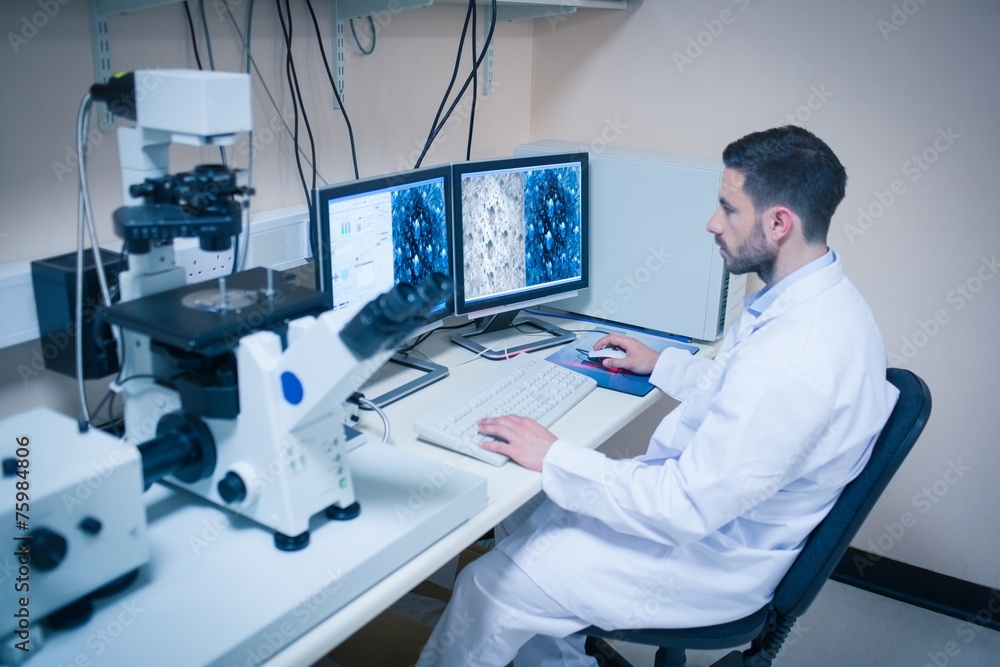 Science student looking at microscopic images