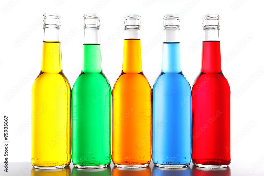 Colorful alcoholic beverages in glass bottles isolated on white Colorful alcoholic beverages in glass bottles isolated on white