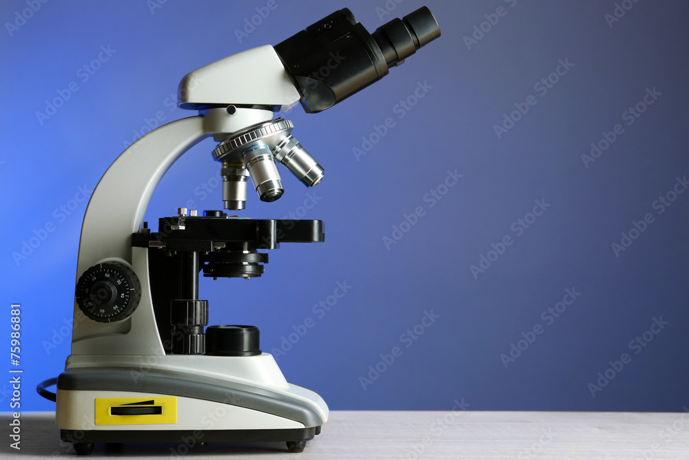 Microscope on table, on color background Microscope on table, on color background