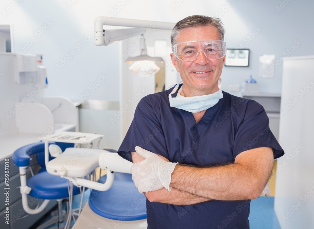 Portrait of a smiling dentist with arms crossed Portrait of a smiling dentist with arms crossed