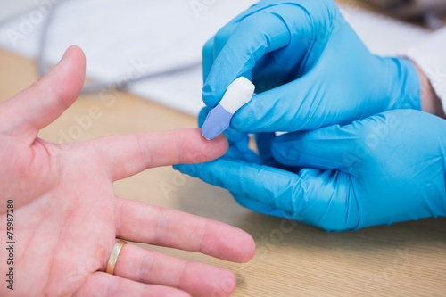 Canvas Print Close up of a doctor testing his patients blood