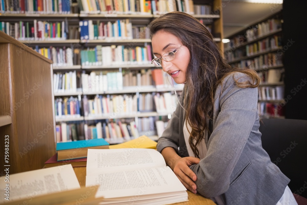 Pretty student studying in the library Pretty student studying in the library
