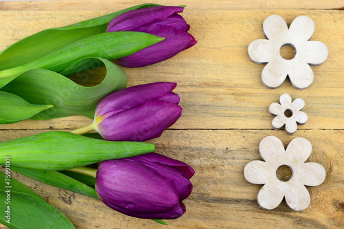 Fototapeta Naklejka Na Ścianę i Meble -  purple tulips and white wooden flowers on old wood