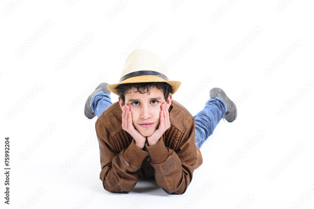Portrait of smiling boy lying down with hat. Portrait of smiling boy lying down with hat.