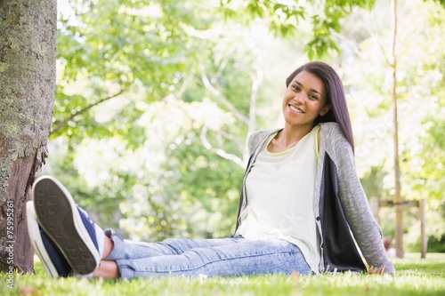 Free Download Pretty brunette smiling at camera in park - GFXLoad
