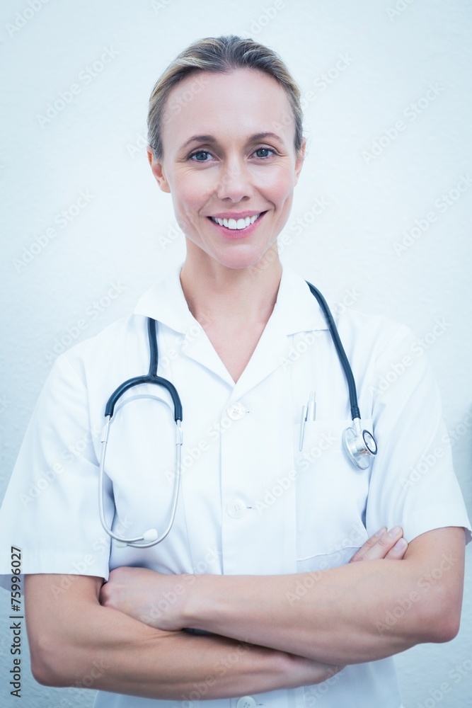 Smiling female dentist with arms crossed Smiling female dentist with arms crossed
