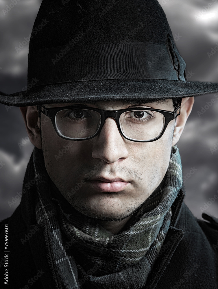 Closeup portrait of a serious young man in black hat Stock Photo ...