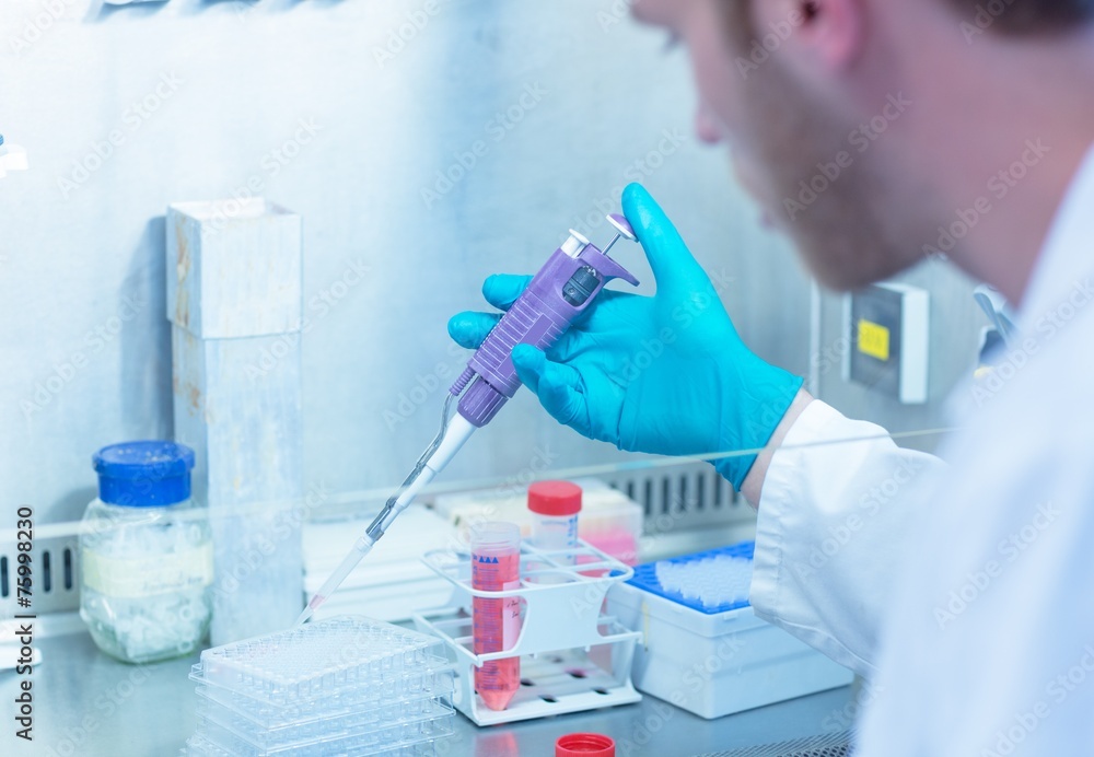 Science student using pipette in the lab Science student using pipette in the lab