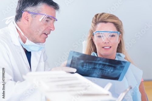 Dentist showing x-ray to his patient