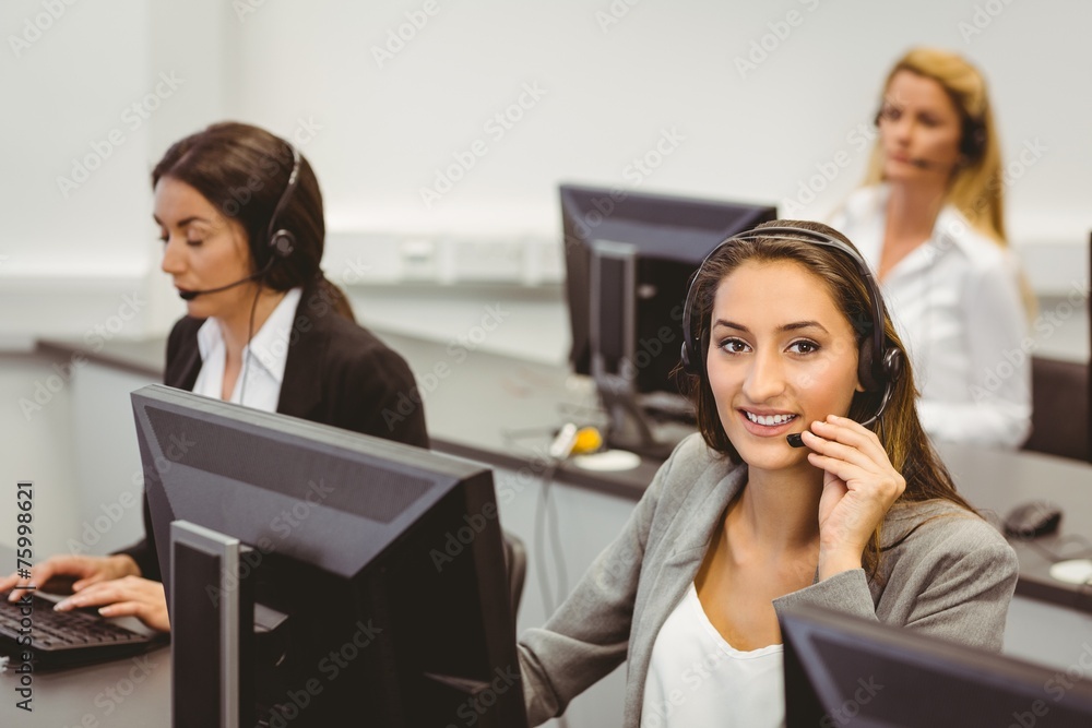 Smiling call centre agent talking on the headset Smiling call centre agent talking on the headset