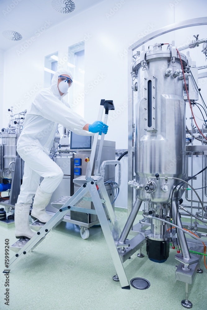 Scientist in protective suit climbing on ladder Scientist in protective suit climbing on ladder