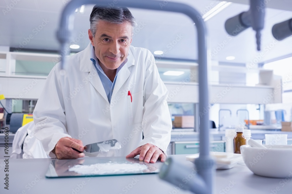 Smiling biochemist preparing some medicine Smiling biochemist preparing some medicine