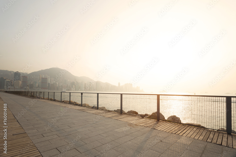 skyline and street near the harbor of hong kong in daytime,