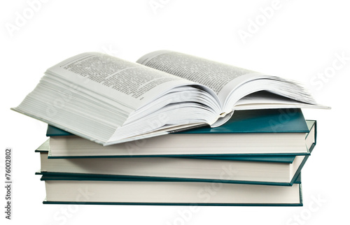 Open book lying on a pile of books