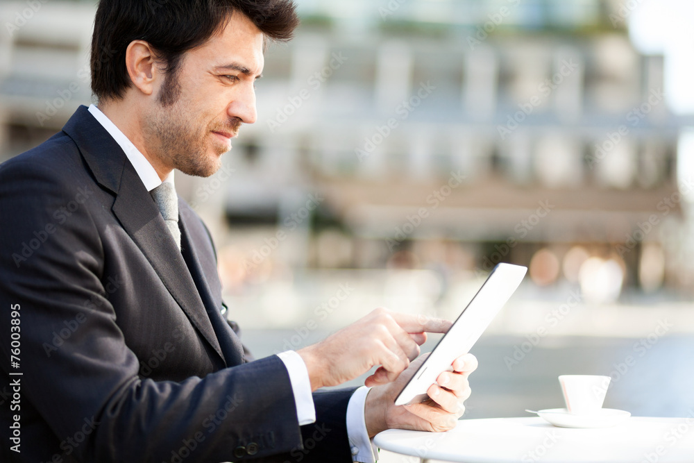 Businessman reading his digital tablet Businessman reading his digital tablet