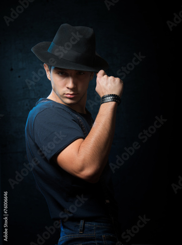 Portrait of a handsome guy with black hat