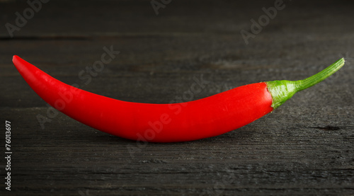 Red chili pepper on wood close-up