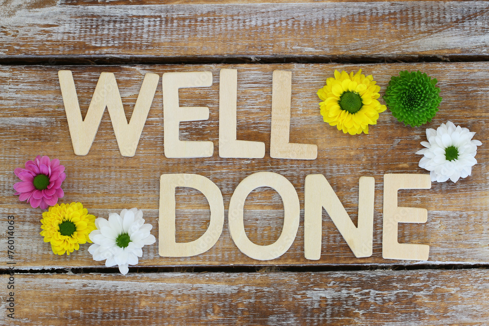 Well done written with wooden letters, and santini flowers