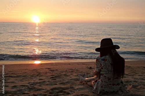Lonely girl took a photo of sunset