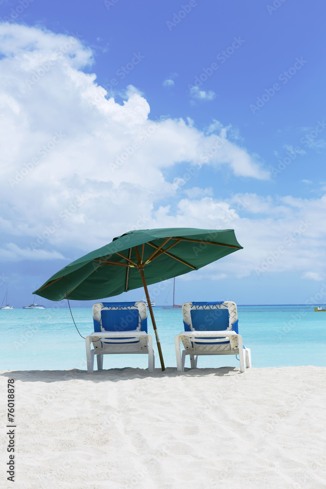 Beach chairs under umbrella