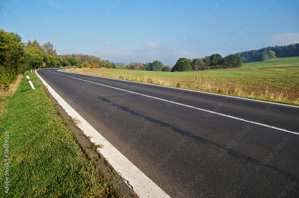 Empty asphalt road in countryside, bend of road