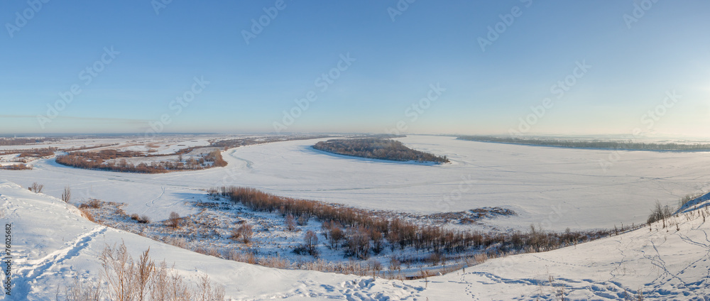 Winter panoramic landscape with frozen river from the high bank