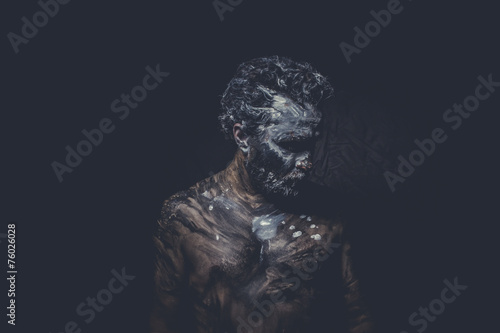 strong naked wild man with tribal paint