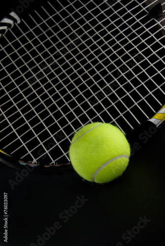 Green Tennis Ball with Racquet Dark Background © rstpierr
