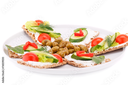 Cracker with fresh vegetables and cream