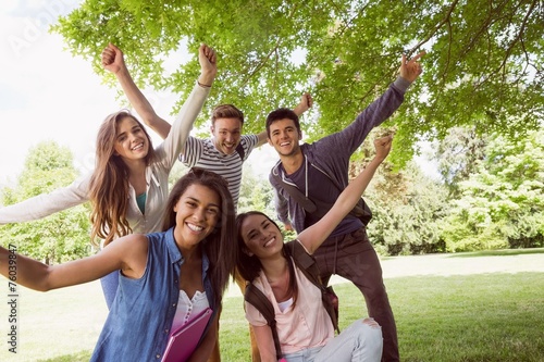 Happy students posing and smiling outside