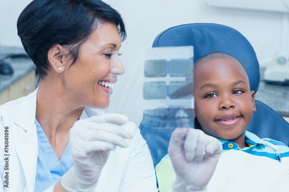 Female dentist showing boy his mouth x-ray Female dentist showing boy his mouth x-ray
