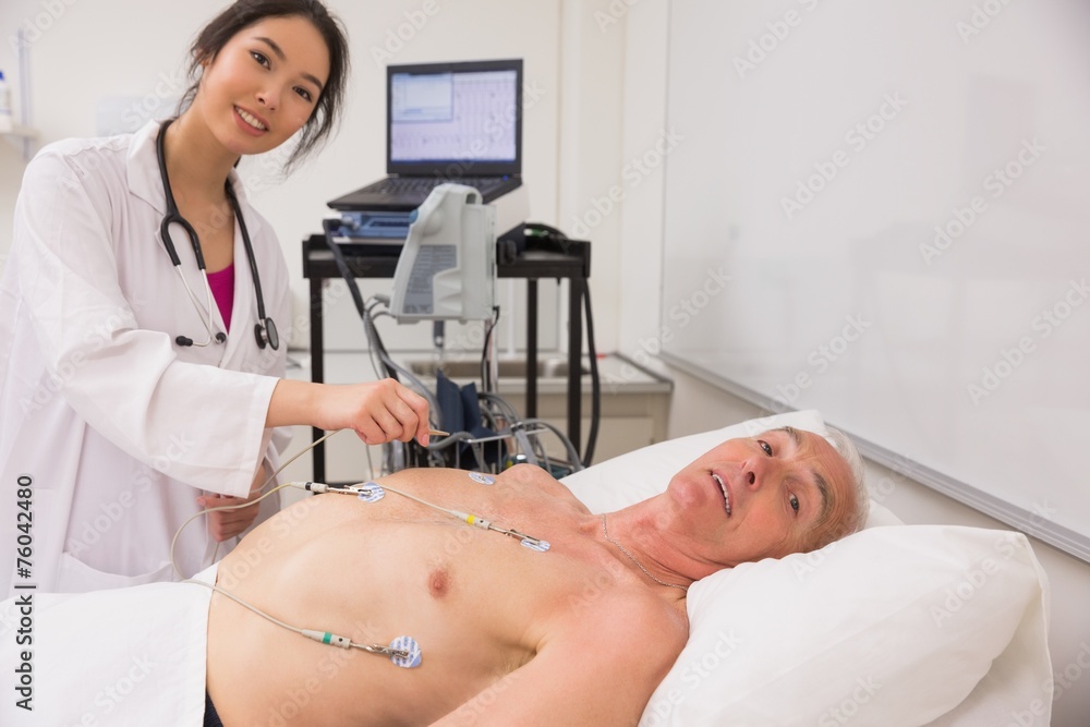 Medical student practicing on older man Medical student practicing on older man
