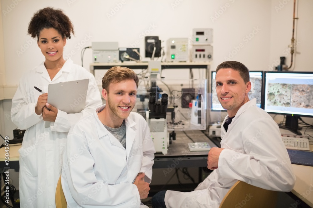 Biochemistry students using large microscope and computer Biochemistry students using large microscope and computer