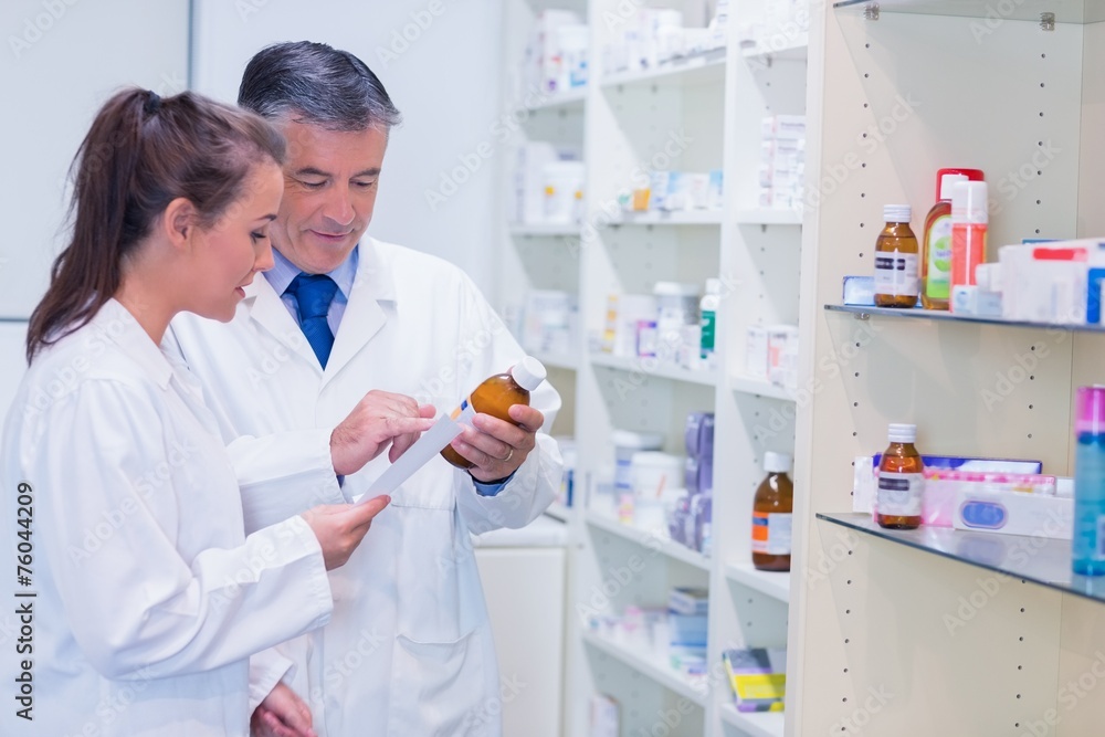 Pharmacist and trainee talking together about medication