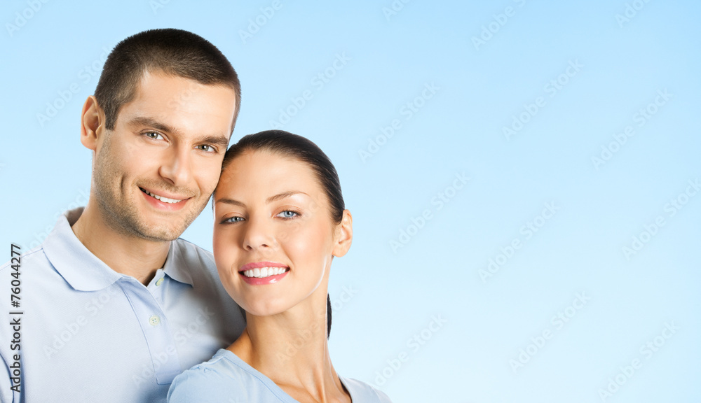 Cheerful young couple, over blue Cheerful young couple, over blue